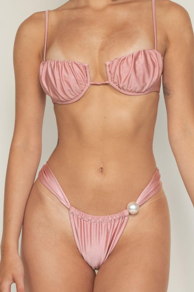Rose pink satin bikini bottom with ruched fabric and pearl button detail at center front.