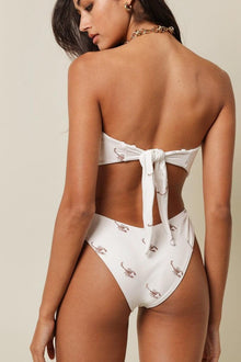 White bikini bottom with brown scorpion print and zig-zag stitch details.