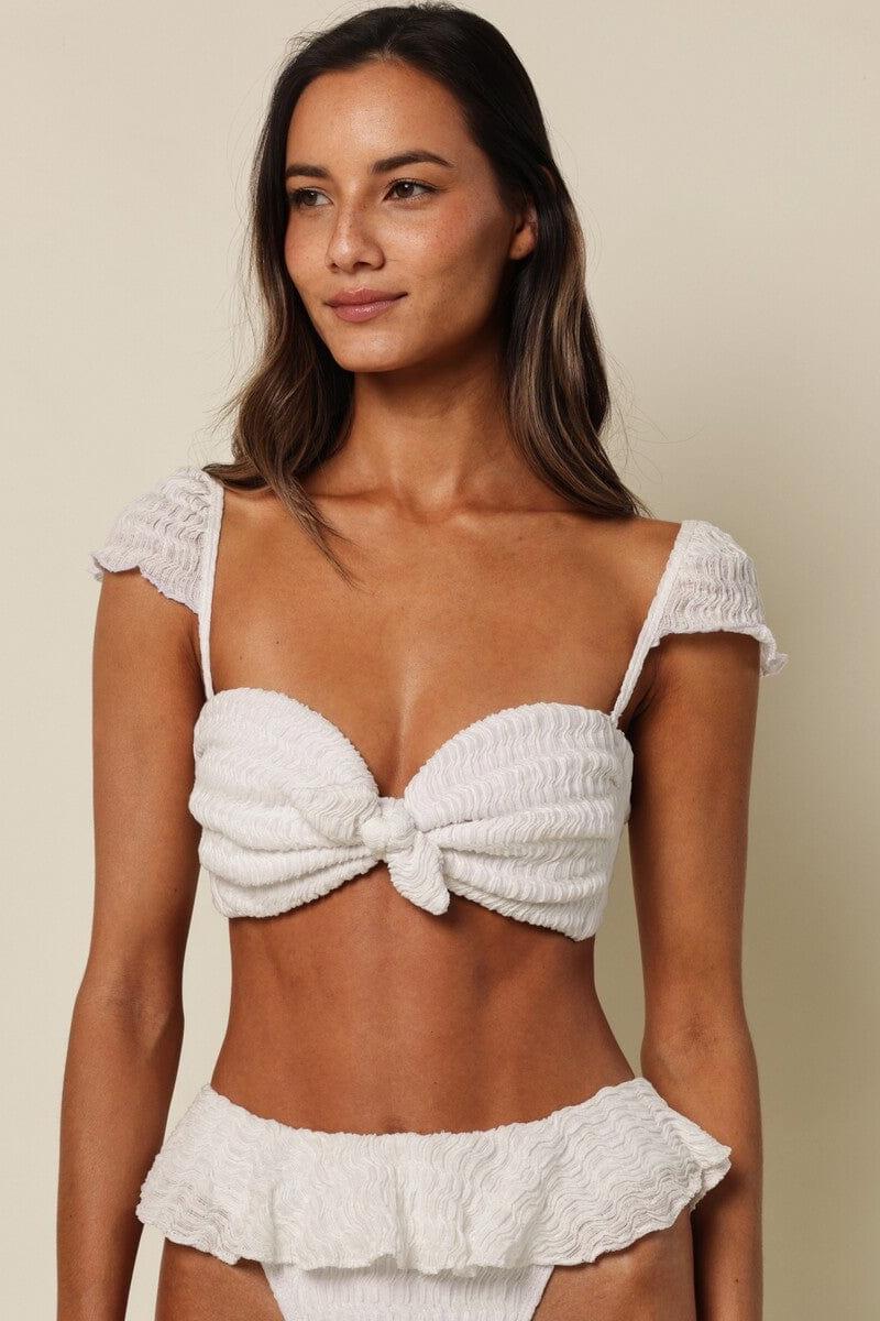 White textured bikini top with bow tie front closure and short ruffled sleeves.
