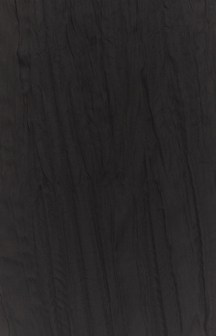 Close-up of the black sheer crinkled fabric texture of the maxi skirt
