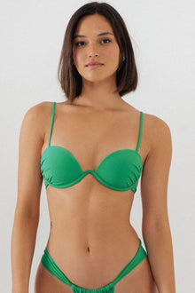 Green bikini top with underwire cups and adjustable spaghetti straps on a model.
