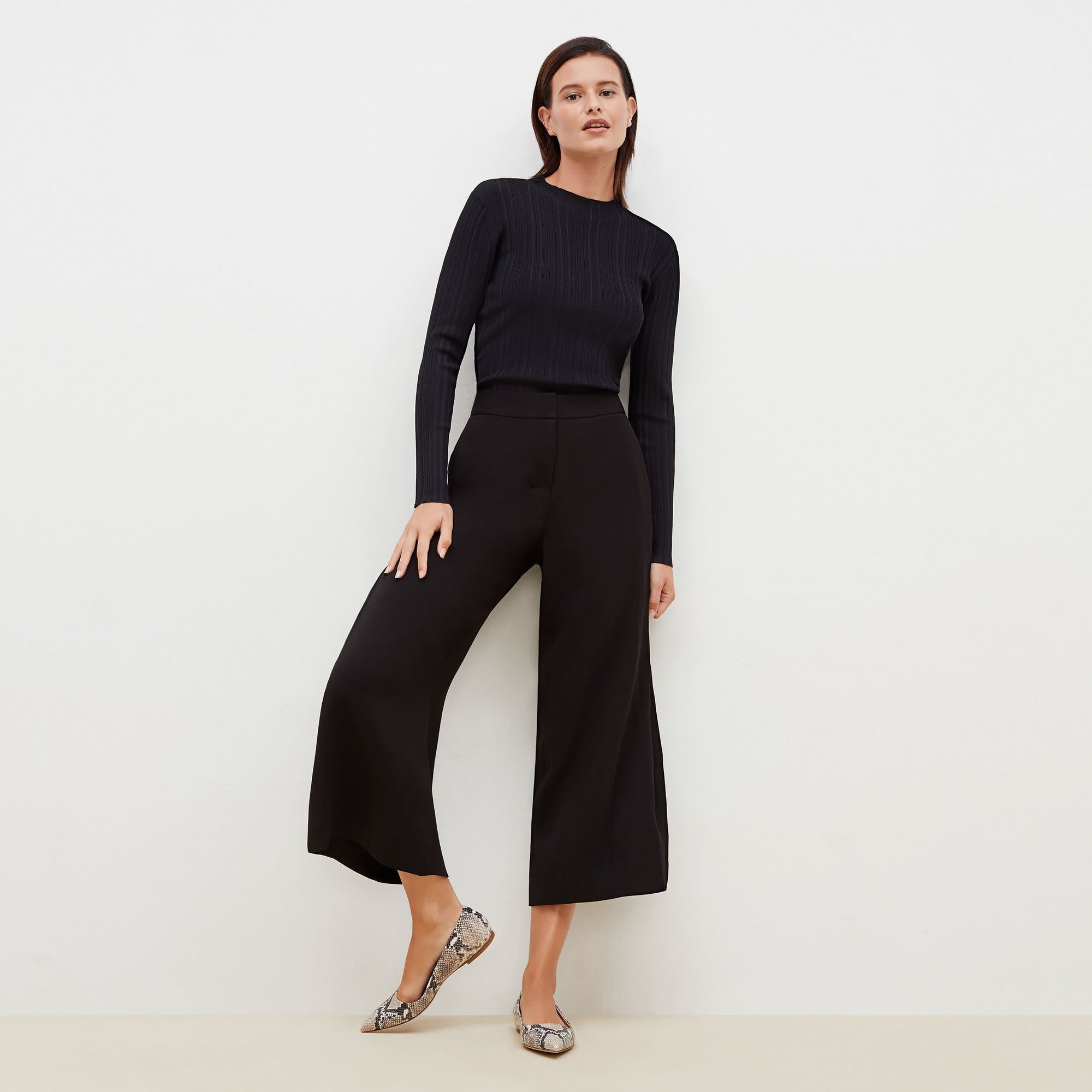 Front image of a woman standing wearing the Zhou culotte in black | Exclude