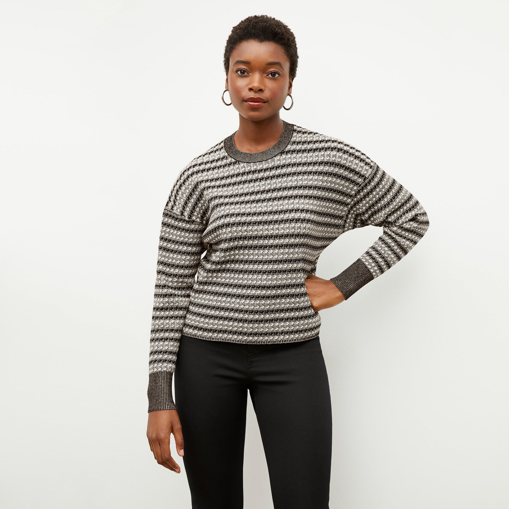 Front image of a woman wearing the tyler sweatshirt in black and white